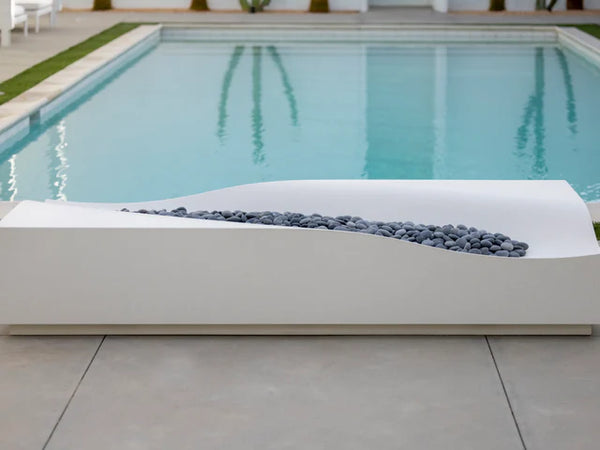 Lumacast Duna -Modern outdoor fire pit with decorative stones by a pool