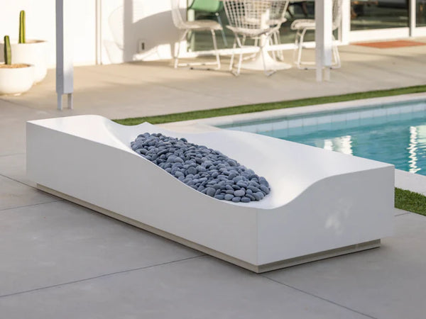 Lumacast Duna -Modern outdoor fire pit with decorative stones by a poolside