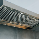 Close-up of a Summerset stainless steel range hood with built-in lights and a ridged filter.